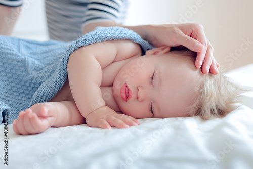 portrait of a sleeping baby, mom put the baby to daytime sleep