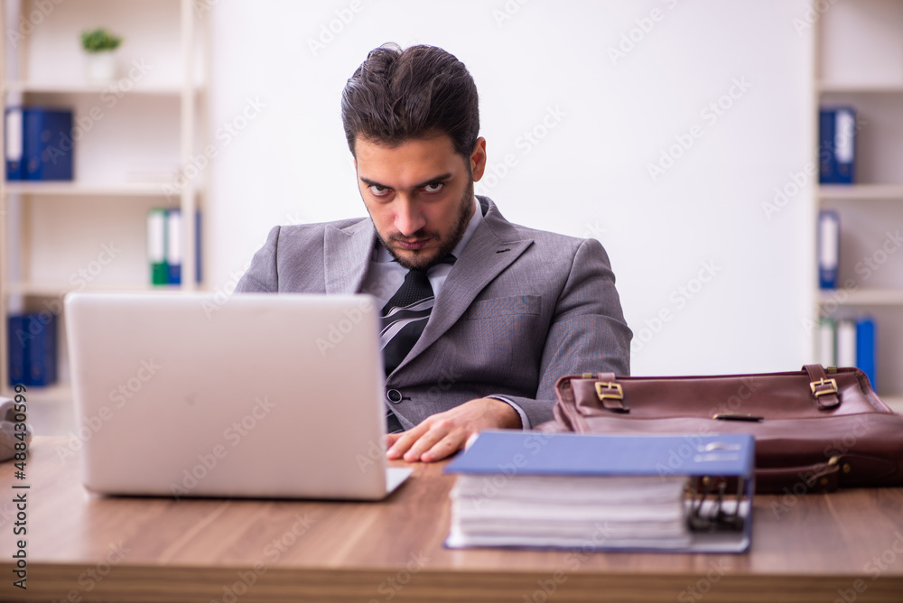 Young businessman employee working in the office Young businessman employee working in the office