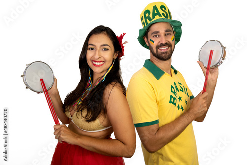 Portrait of a couple in costumes playing tambourine. White background. Happy couple photo