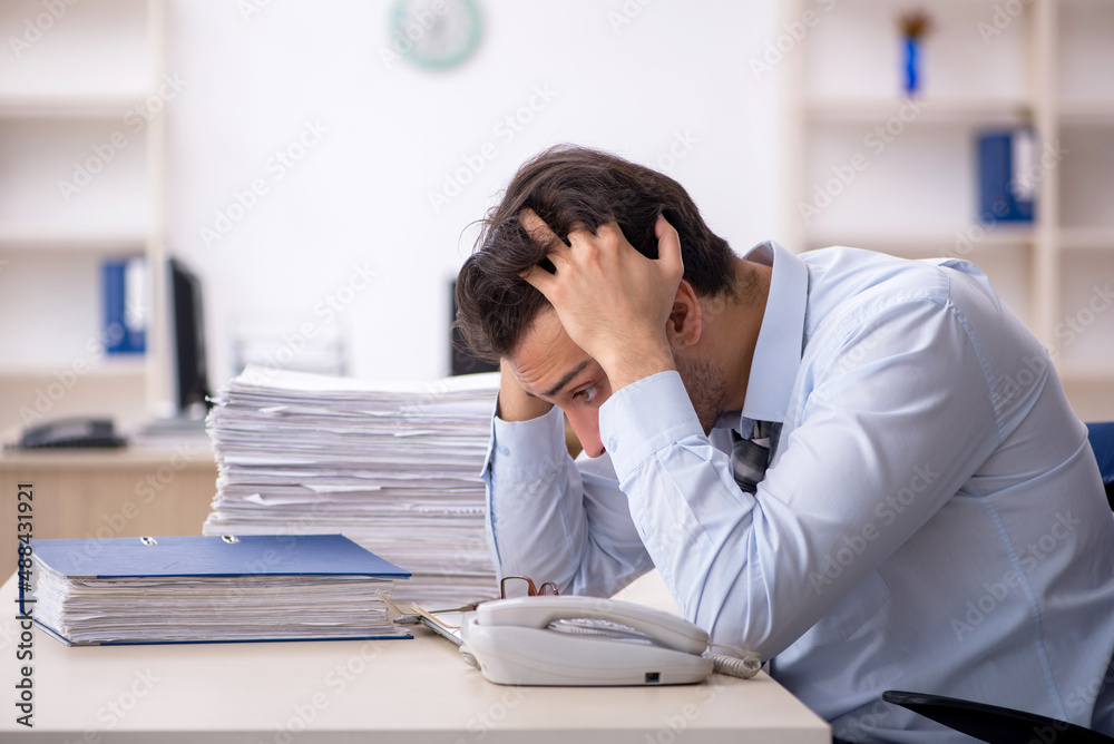 Young male employee working in the office Young male employee working in the office
