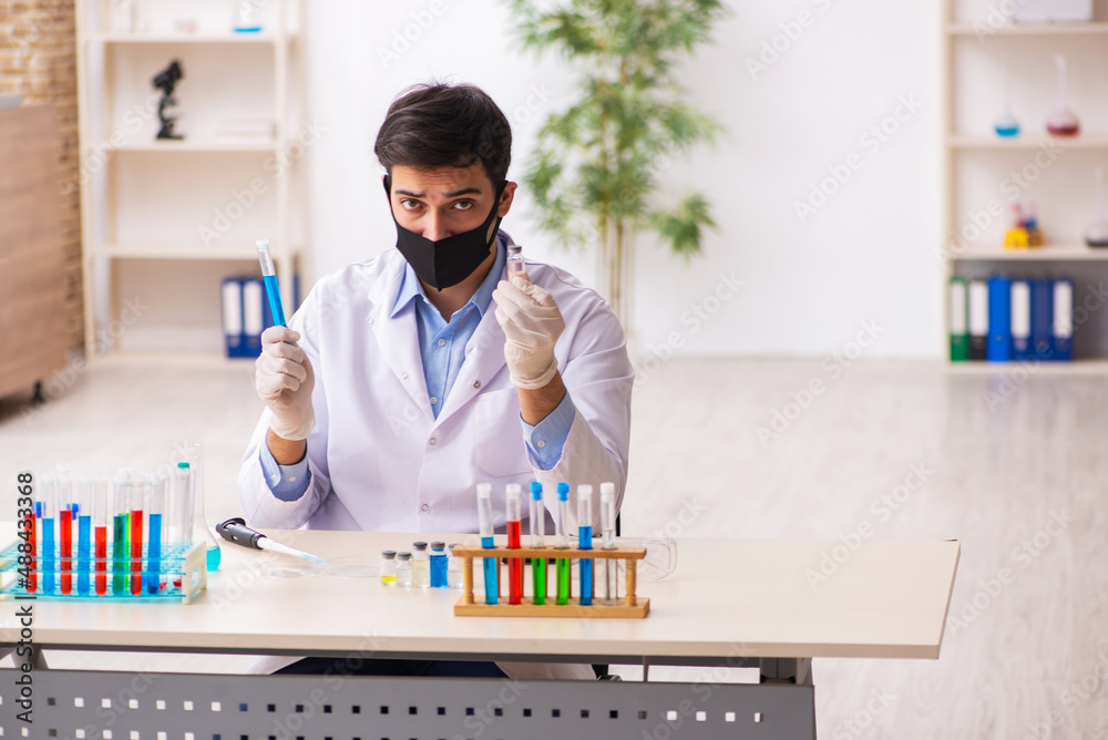 Young male chemist working at the lab during pandemic Young male chemist working at the lab during pandemic