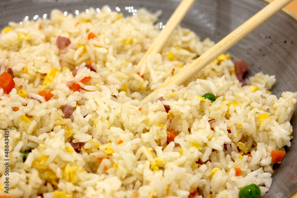 Chinese rice 3 delicacies with chopsticks