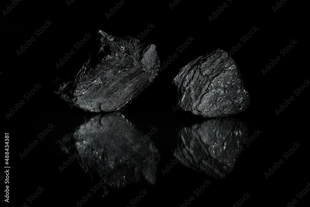Naklejka premium Mineral carbon. A desktop picture. Relief stones with reflection. Photo for a desktop and home screen . 