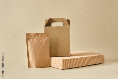 boxes and paper zip bags on a beige background, mock-up packaging for products, packages for delivery