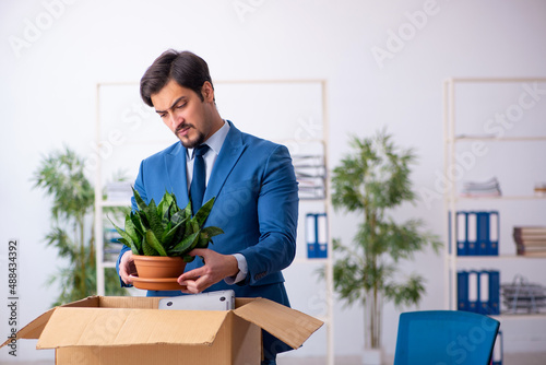 Young male employee in business relocation concept