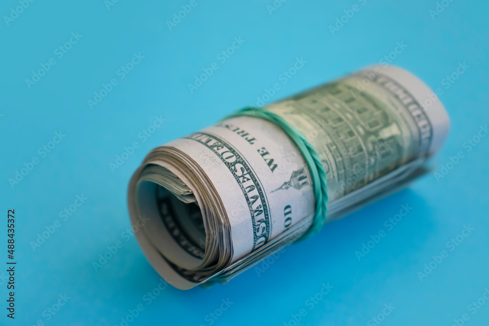 stack of dollars on a colorful background stack of dollars on a colorful background