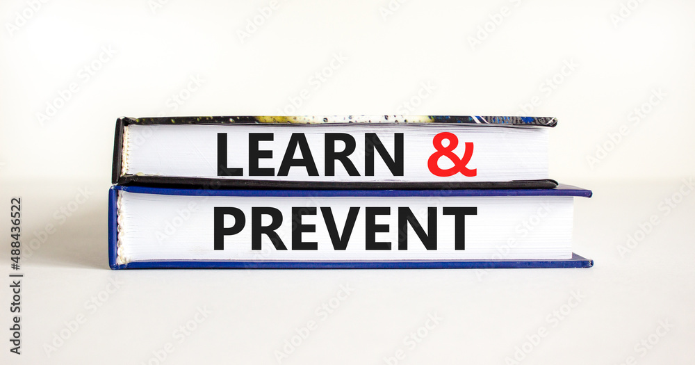 Learn and prevent symbol. Concept words Learn and prevent on books on a beautiful white table white background. Business learning and learn and prevent concept, copy space.