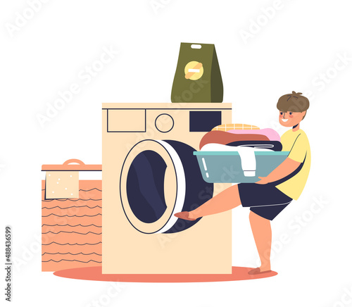 Boy kid loading clothes to washing machine. Small child help do housework at home