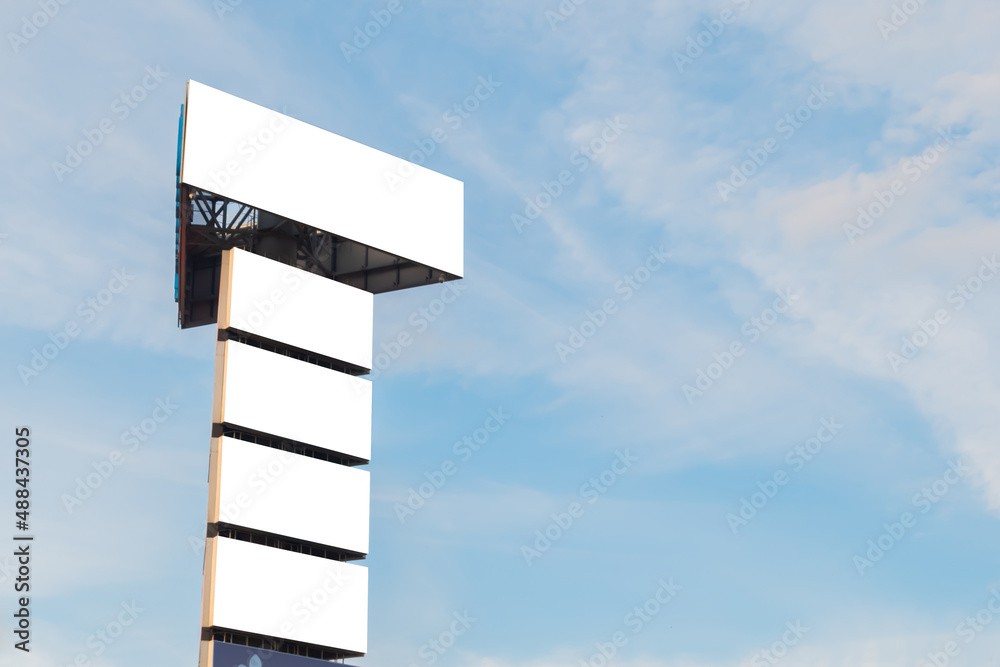 Mock up image: five blank white billboards or large displays on tower against blue sky. Mockup, white screen, background, consumerism, advertising, template, copyspace concept Mock up image: five blank white billboards or large displays on tower against blue sky. Mockup, white screen, background, consumerism, advertising, template, copyspace concept
