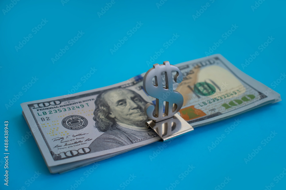 stack of dollars on a colorful background stack of dollars on a colorful background