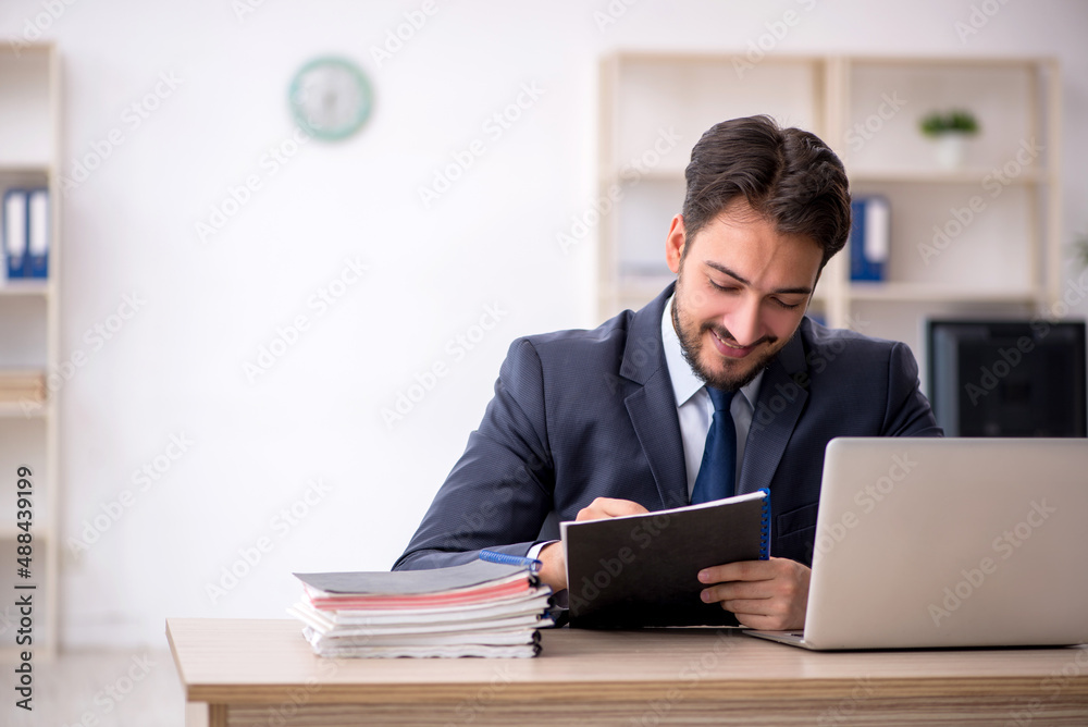 Young male employee working in the office Young male employee working in the office
