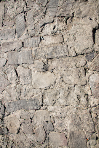 Close-up of a fragment of an old natural white limestone wall.