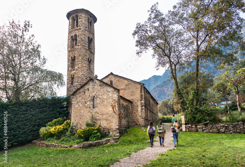 Tourists visiting Església de Santa Coloma, Andorra's oldest church, romanesque style, path leading towards the entrance photo