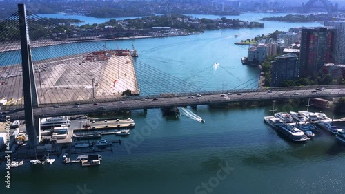 Aerial drone pullback view of Anzac Bridge across Johnstons Bay between Pyrmont and Glebe Island in Rozelle, Sydney on a sunny morning   photo