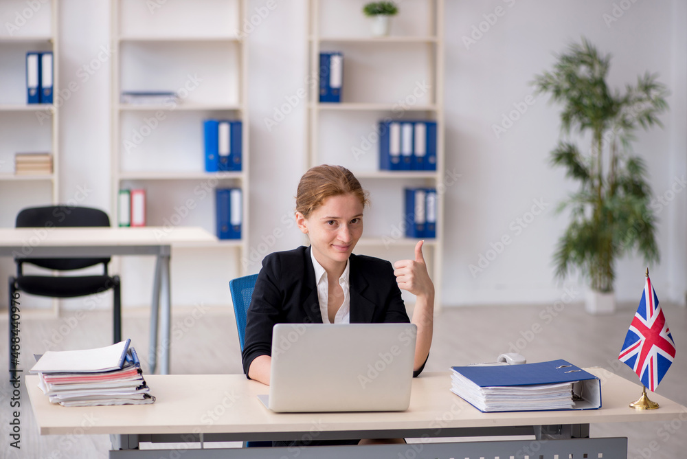 Young female employee working in the office Young female employee working in the office