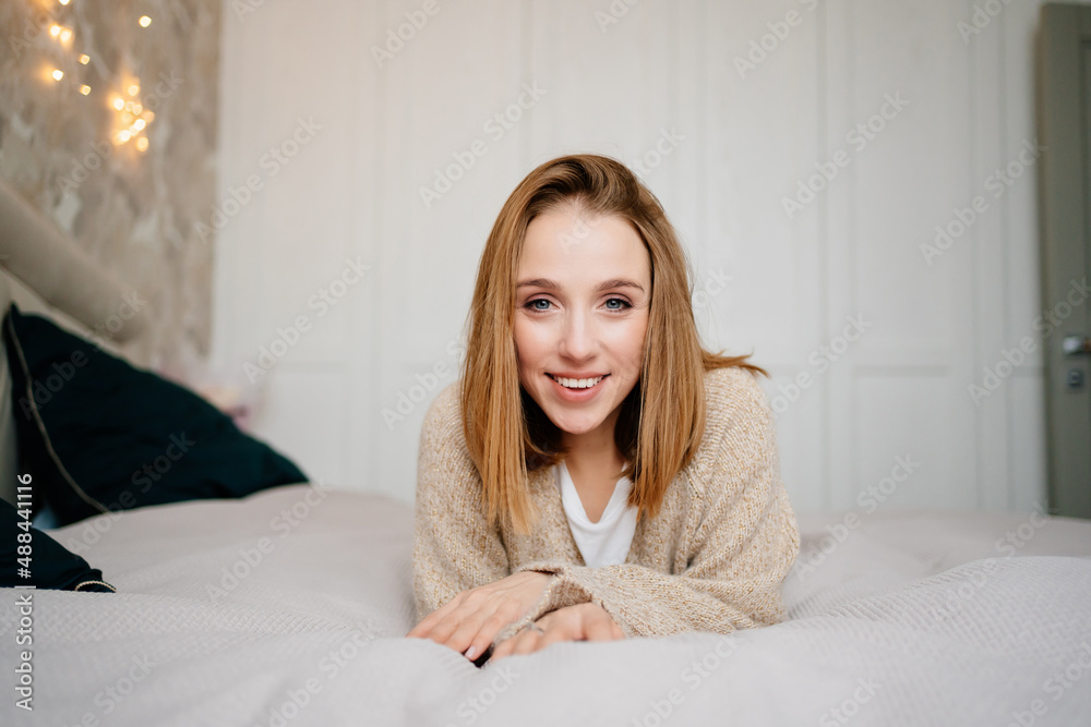 an attractive young woman in a cozy sweater. natural beauty and cosmetics.