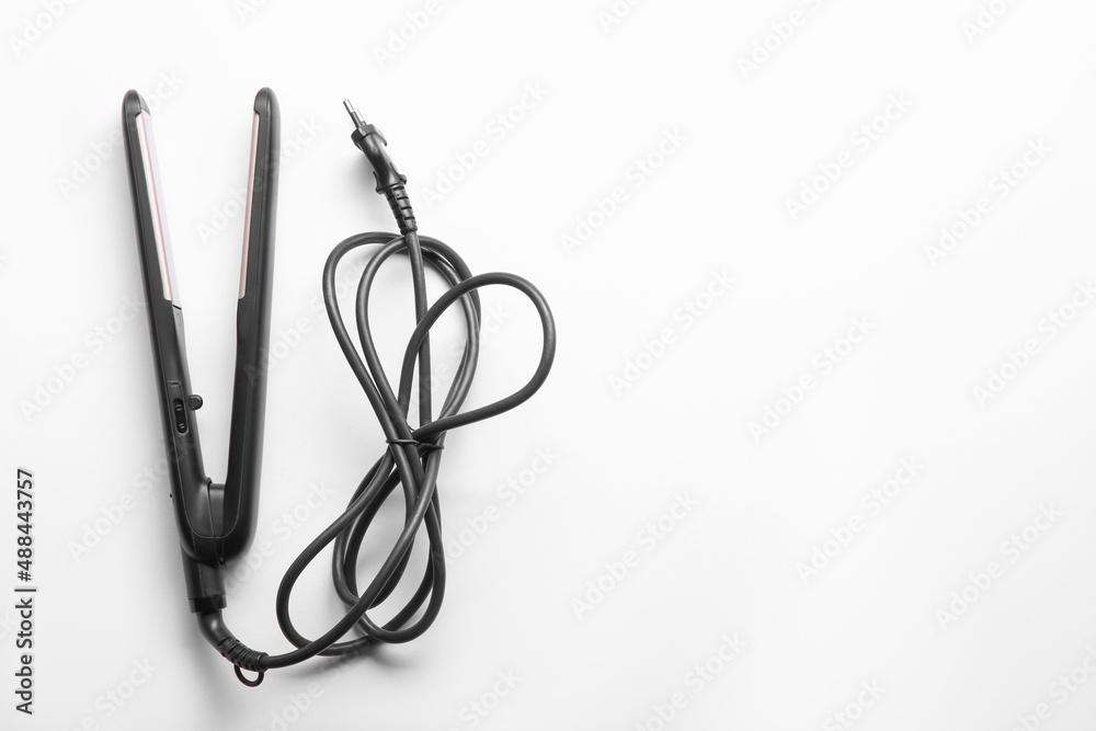Naklejka premium Modern flat hair iron isolated on white, top view