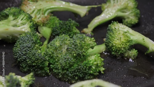 frying broccoli on oil fry pan 4k photo