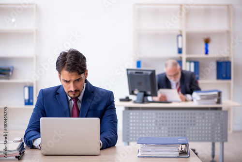 Two male colleagues working in the office