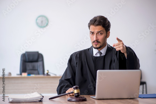 Young male judge working in the courthouse