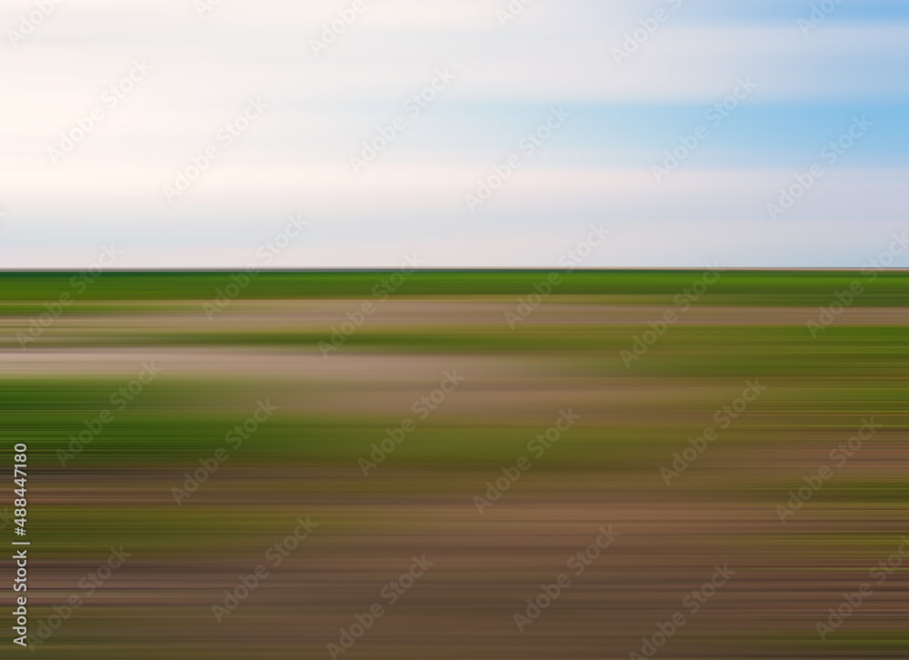 blurred modern minimalist abstract summer country landscape with green and brown land and blue sky