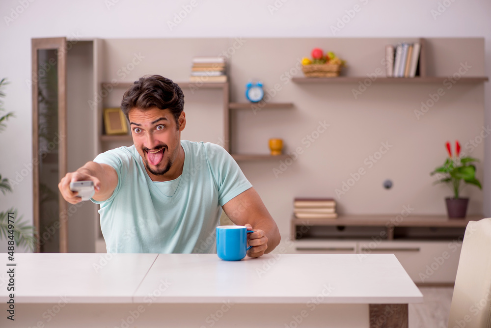 Young man watching tv at home Young man watching tv at home