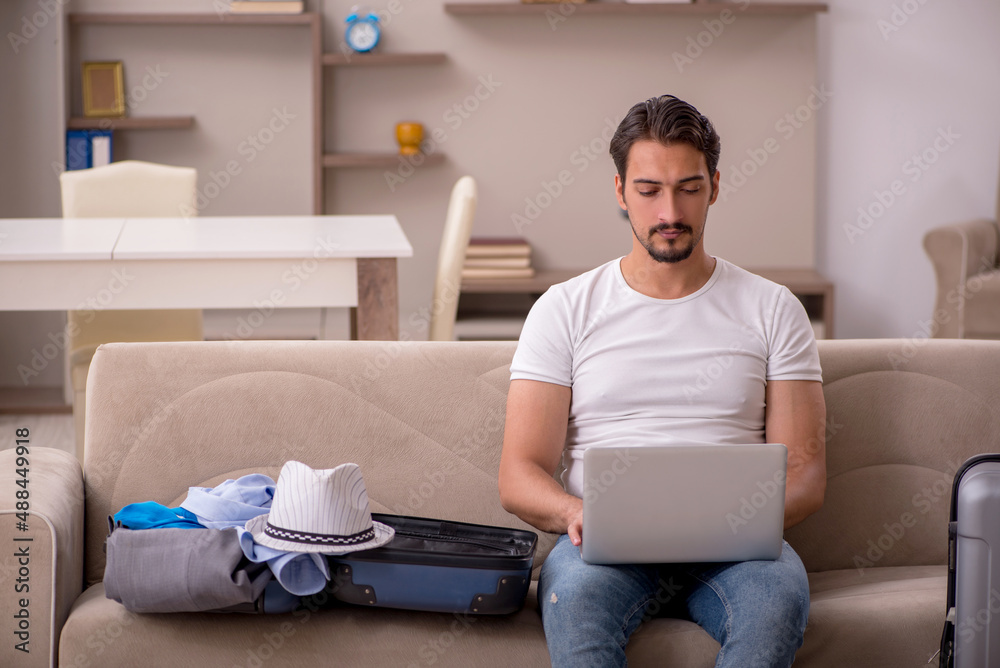 Young man preparing for trip at home Young man preparing for trip at home