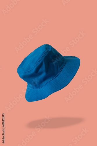 Obraz na płótnie blue bucket hat, coral background 