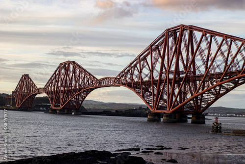 Forth Bridge in Edinburgh in cloudy spring weather as seen from South.