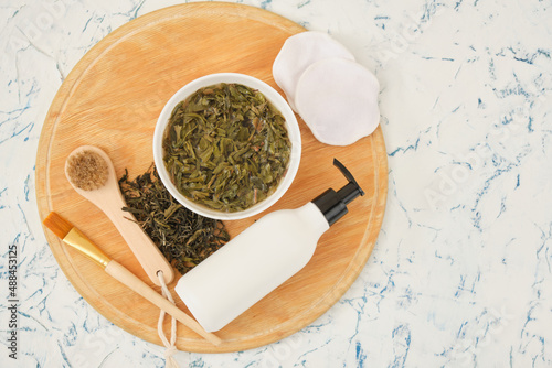 mockup bottle with dispenser and fermented tea tincture on wooden odnos top view photo