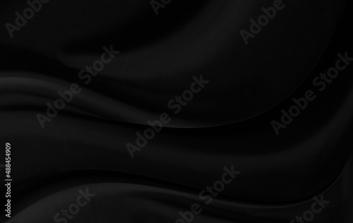 Black gray satin dark fabric texture luxurious shiny that is abstract silk cloth background with patterns soft waves blur beautiful.