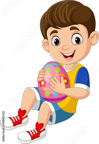 Cartoon little boy holding an easter egg