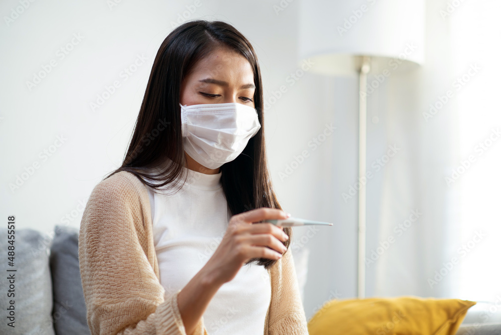 Attractive Asian teenage girls use a temperature measuring device Shows symptoms of fever, headache, flu. Attractive Asian teenage girls use a temperature measuring device Shows symptoms of fever, headache, flu.
