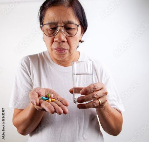 senior woman holding medicine