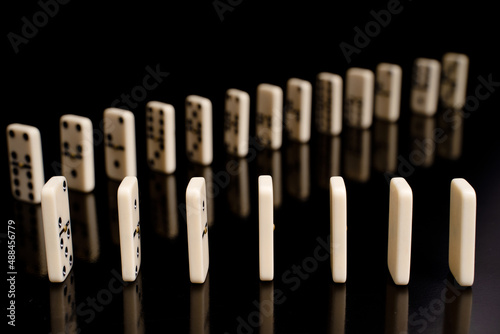 Close-up of domino game on a black background.