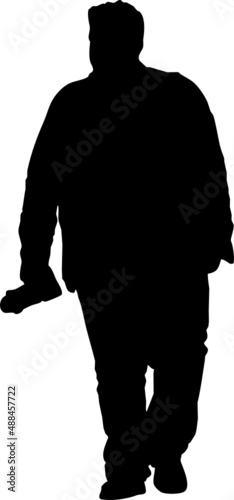 Silhouette d'homme qui marche avec un appareil photo dans la main. 