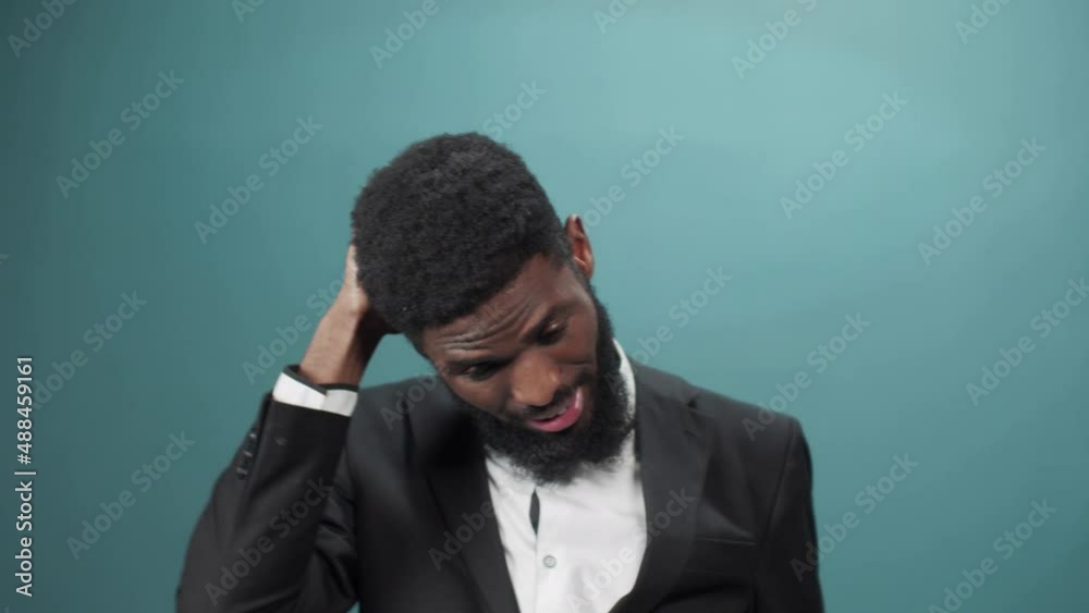 A handsome african man in a tuxedo has some problems and he tries to find a solution of it A handsome african man in a tuxedo has some problems and he tries to find a solution of it