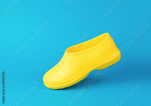 Walking yellow rubber galoshes insulated on a white background. Shoes for rainy weather.