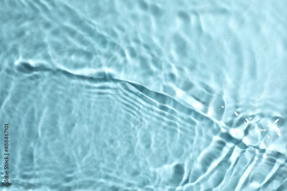 Closeup view of water with rippled surface on turquoise background