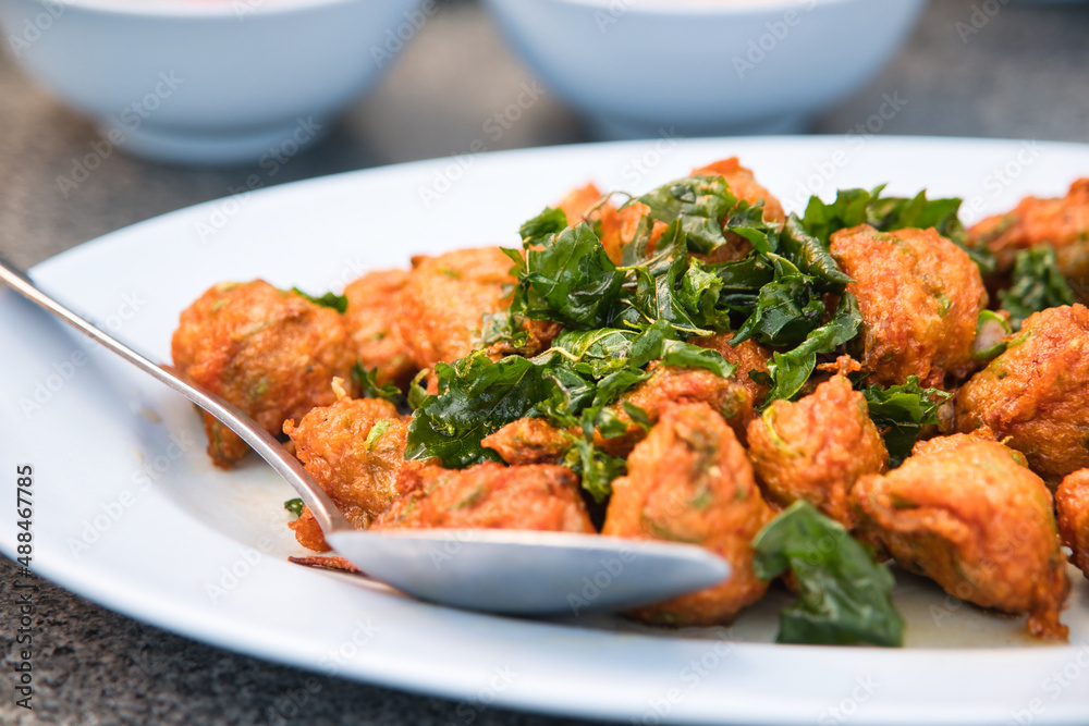 Deep fried fish cakes and crispy basil leaves Suitable for food menu illustrations, background or wallpaper Deep fried fish cakes and crispy basil leaves Suitable for food menu illustrations, background or wallpaper