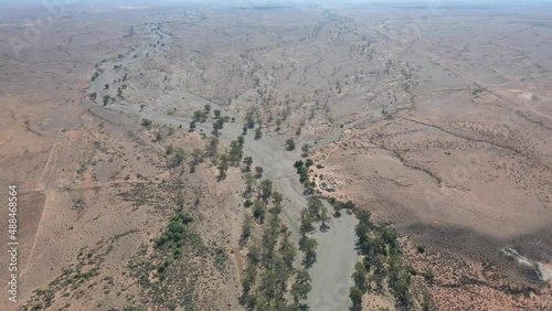 Aerial view slowly tilt up from Brachina Gorge to outback horizon, Flinders Ranges. photo