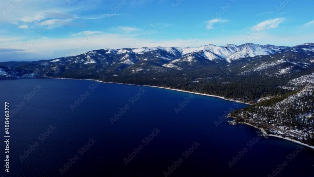 Aerial drone shot, a static shot of the crystal clear lake with the mountains in the background at Lake Tahoe, Nevada-California. Aerial drone shot, a static shot of the crystal clear lake with the mountains in the background at Lake Tahoe, Nevada-California.