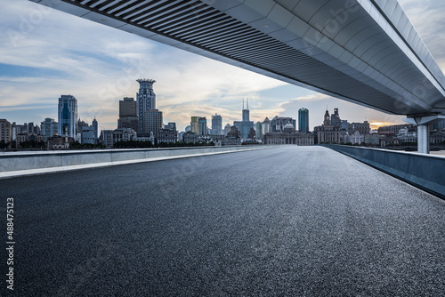 Empty asphalt road and city skyline with modern buildings in Shanghai, China.