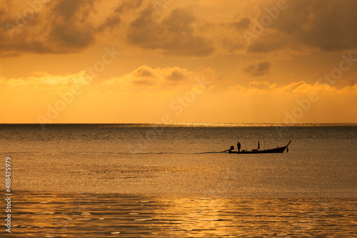 Long-tail boat ride on the sunset over the sea