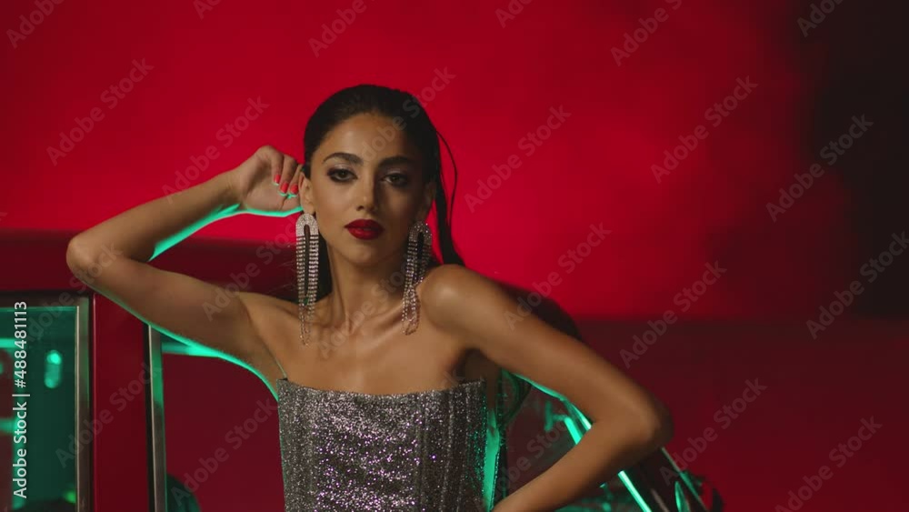 Beautiful Elegant Young Woman Standing , Dancing and Flirting near old retro classic car. Old fashioned luxury style concept . Rich fashion lifestyle . Luxury dress with fabric glitter, spangles .