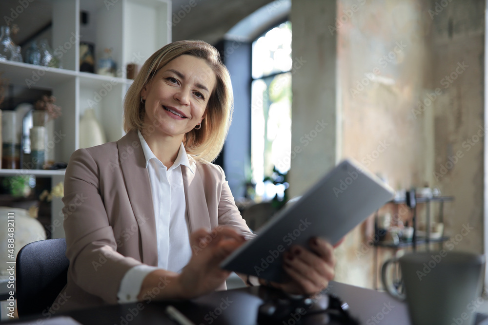 Beautiful business woman on the workplace using a digital tablet. Beautiful business woman on the workplace using a digital tablet.