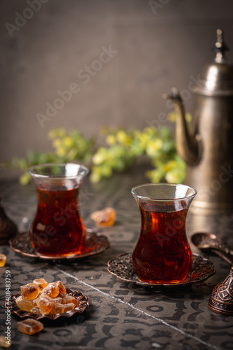 Turkish tea in traditional glass closeup on tile background