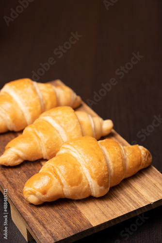 Fresh croissants on a wooden board. selective focus .bakery with copy space.