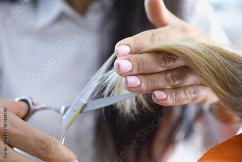 Female holding metal scissors