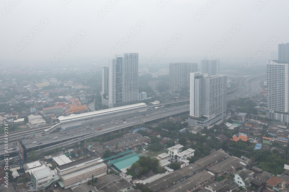 Aerial view of highway street road at Bangkok Downtown Skyline, Thailand. Financial district and business centers in urban city in Asia. Skyscraper buildings with fog. Air pollution pm2.5 Aerial view of highway street road at Bangkok Downtown Skyline, Thailand. Financial district and business centers in urban city in Asia. Skyscraper buildings with fog. Air pollution pm2.5